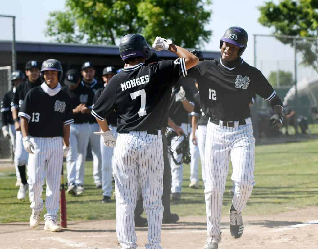 Photo - Madera South’s Murf Gray celebrates with Brian Monges at home plate after Gray hit a two-run home run in the first inning of Wednesday’s victory over the Clovis Cougars.