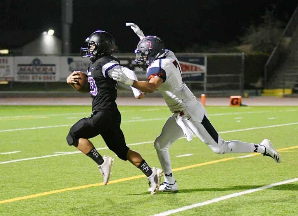 Photo - Madera South’s Mathew Manoz races ahead of San Joaquin Memorial’s Austin Yniguez during an 89-yard return on the opening kickoff of Friday’s loss.