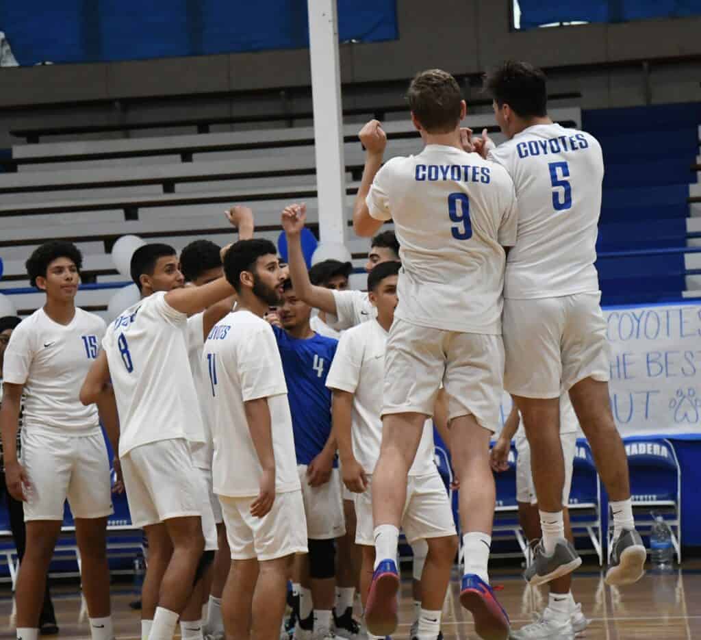 Photo - Madera’s Hunter Brown (9) and Seth Valencia (5) and the rest of the Madera Coyote boys volleyball team celebrates a three-set victory over Kipp King in the quarterfinals of the CIF State Div. III NorCal playoffs in Joe Flores Gym