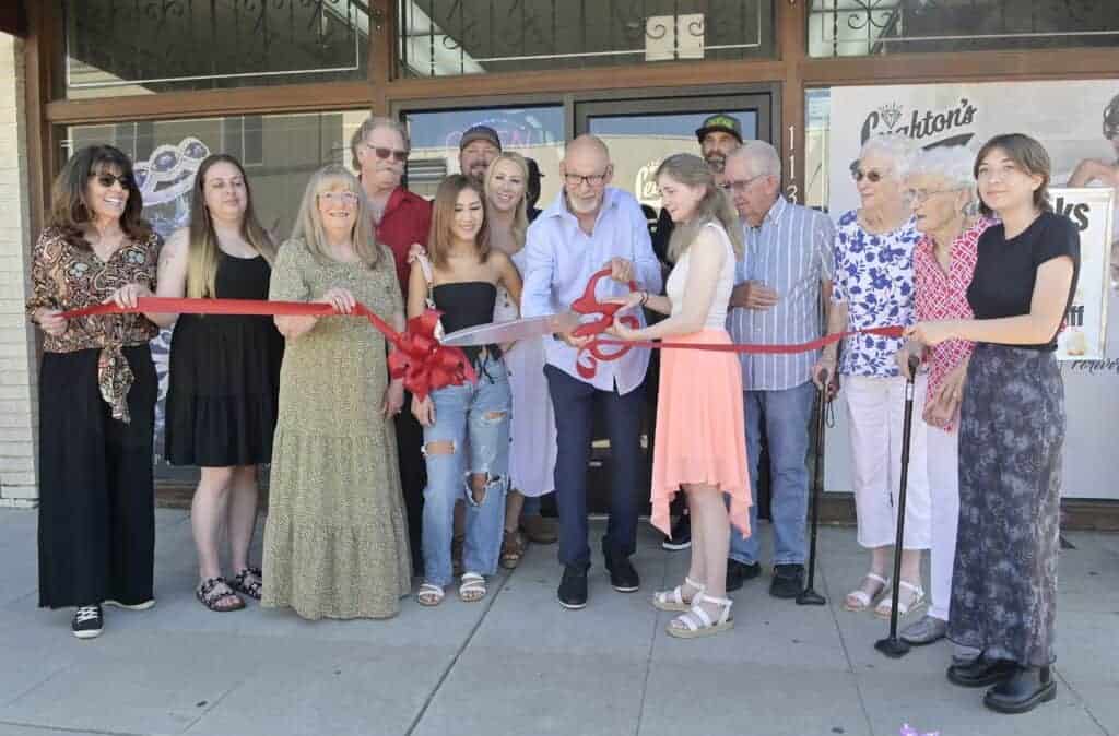 Photo - Business partners Virgil Anderson and Suzie Gran, holding scissors, cut the ribbon for their business, Leighton’s Custom Jewelry & Repair, during a ceremony on Thursday.