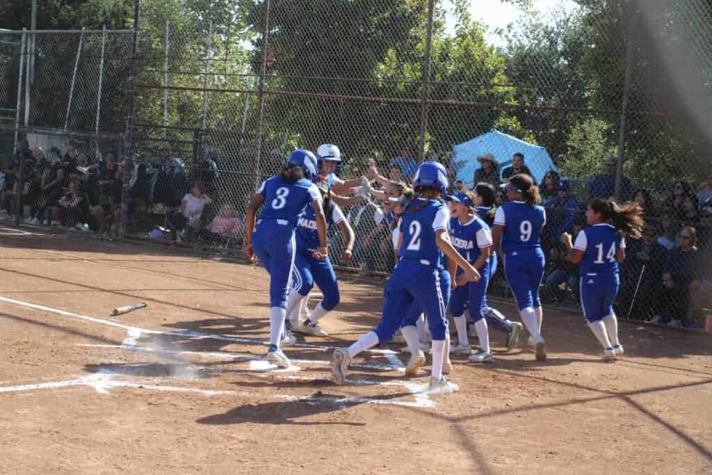 Photo - Madera’s Kailea Ricks (3) hits home plate and gets ready to run through a tunnel of Coyote softball players after hitting her first home run of the season to give the Coyotes an early 1-0 lead in Friday’s 3-1 victory over St. Joseph’s in Santa Maria.