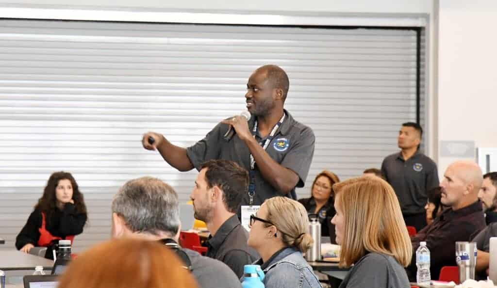 Photo - An animated Babatunde Ilori, MUSD executive director for accountability and communications, gestures during a training session for administrators following an earlier staff development kick-off at Roger Rocka’s.