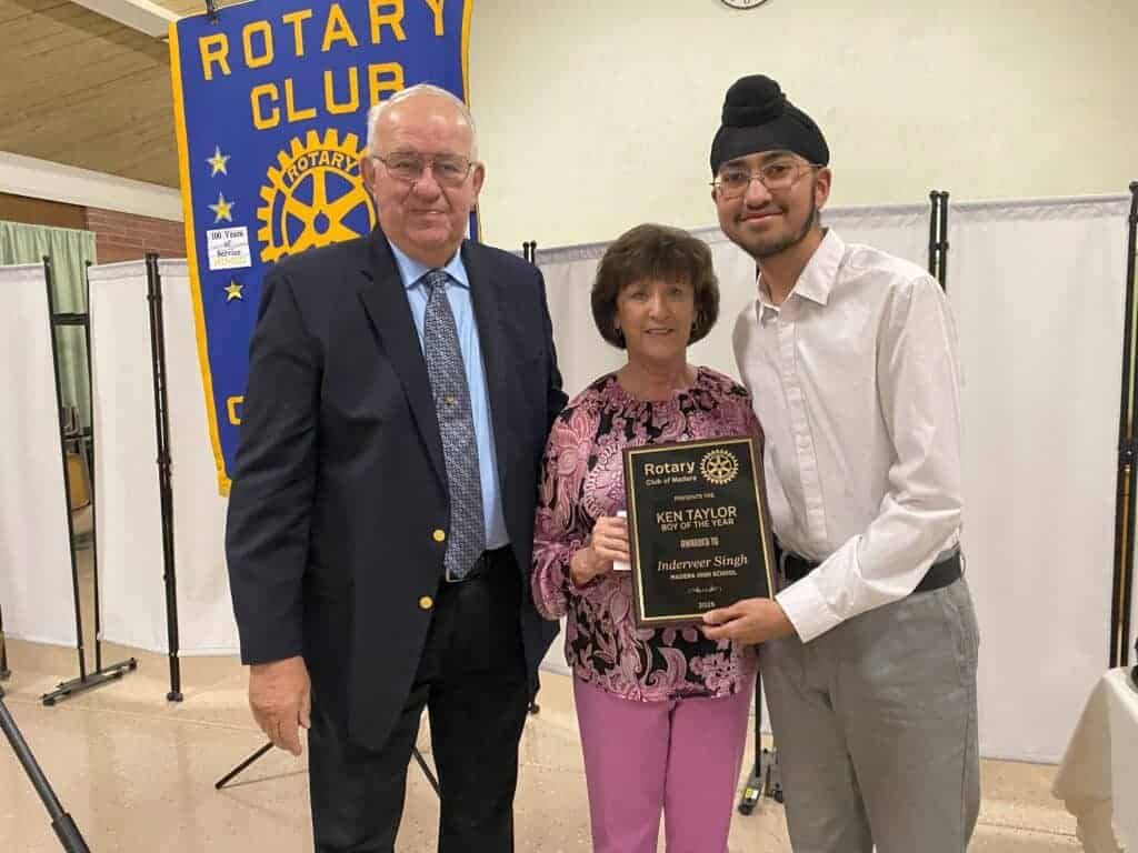Photo - Ken Taylor’s brother-in-law, Ron Pisk, and sister, Terri, award Inderveer Singh of Madera High School the Boy of the Year scholarship.