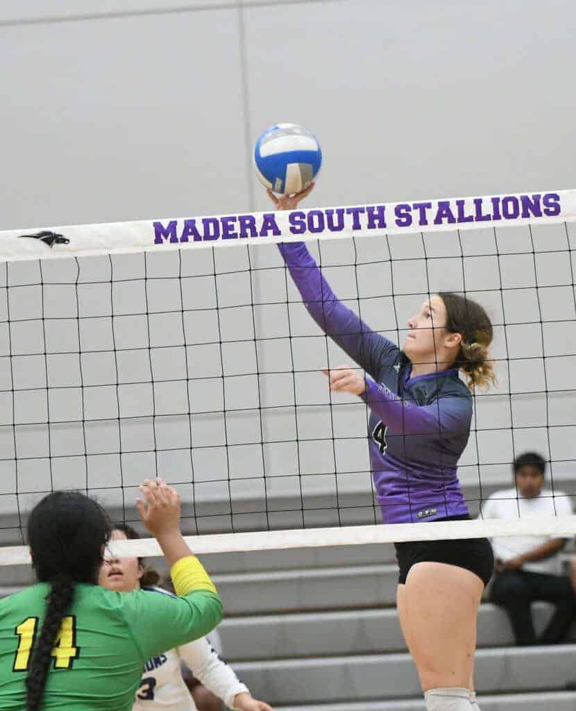 Photo - Madera South’s Hannah Eades tips the ball over the net during Thursday’s three-set victory over Roosevelt.