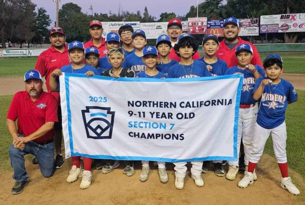 Photo - With the scoreboard over their shoulders telling the 4-2 final, the Madera American Little League 9-11-year-old All-Star team celebrates winning the Section 7 championship after a victory over Porterville on Sunday.