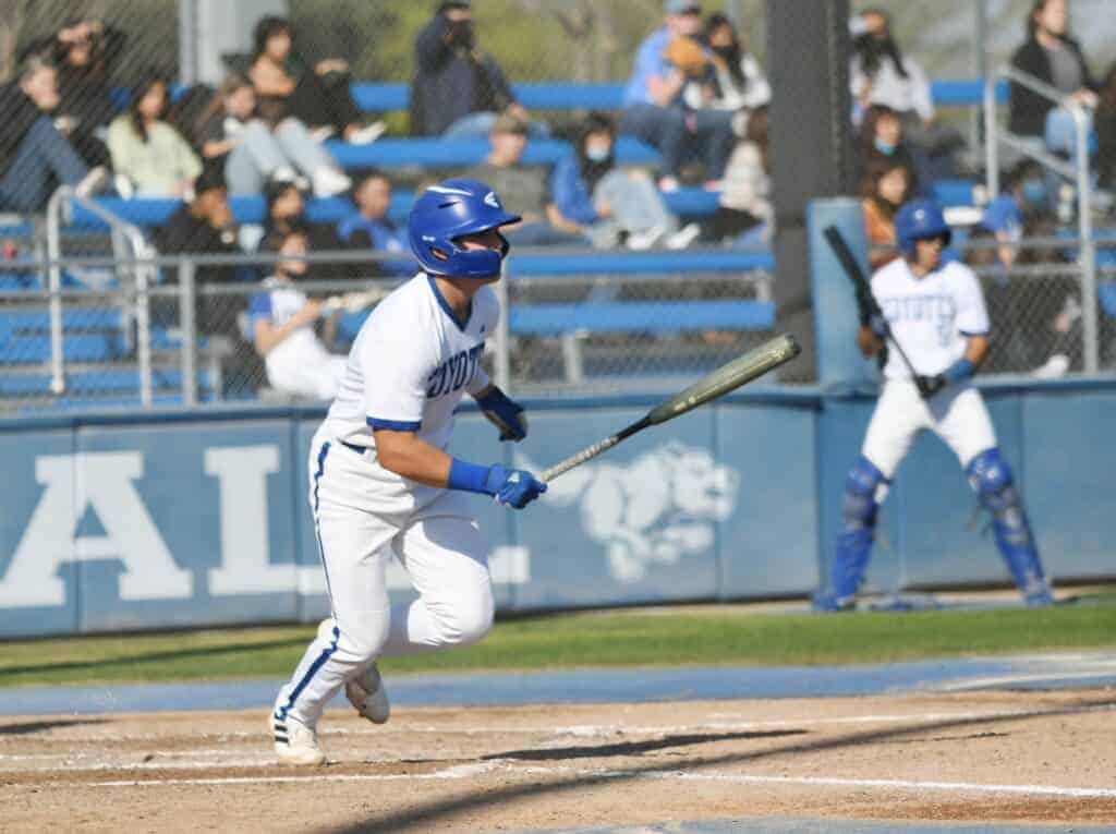 Photo - Madera’s Eric Wilson watches his first inning single land to drive in Logan Wattenbarger for the first run of the game in Tuesday’s loss to Hanford.