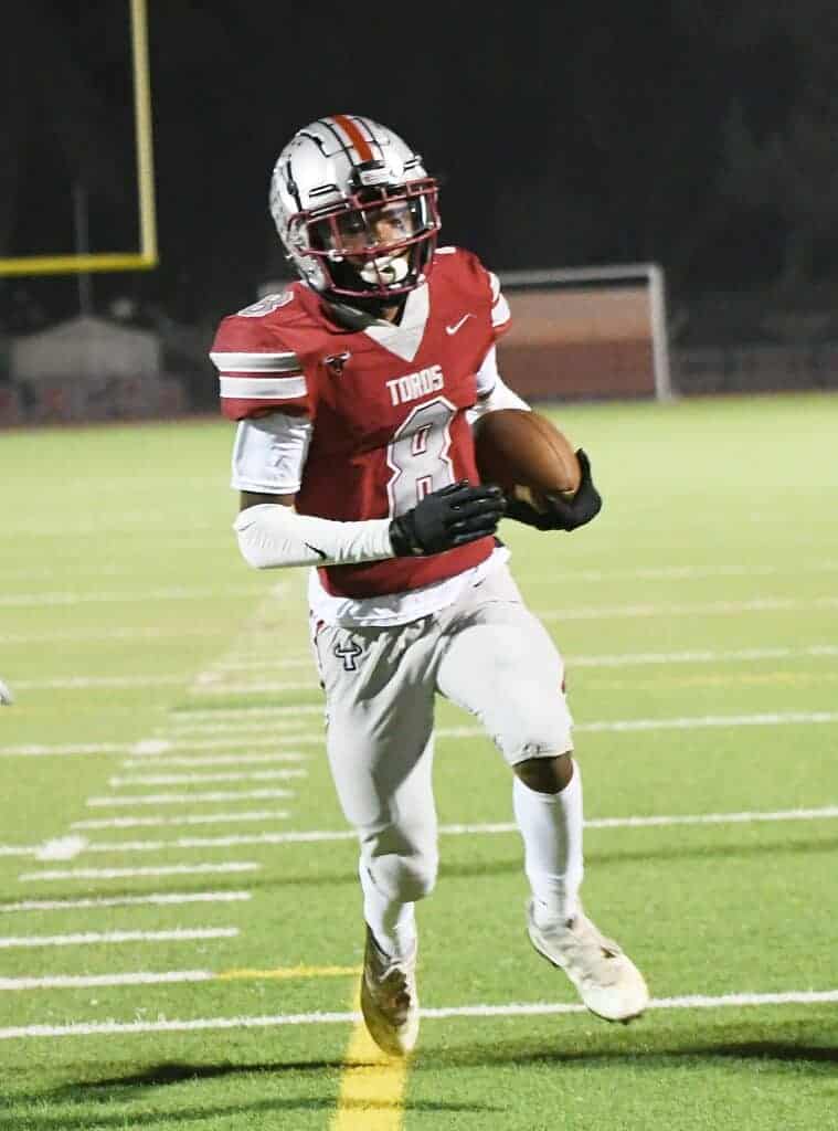 Photo - Matilda Torres High School’s Lawrence Watson scores a touchdown during the Friday night game against Fresno High.