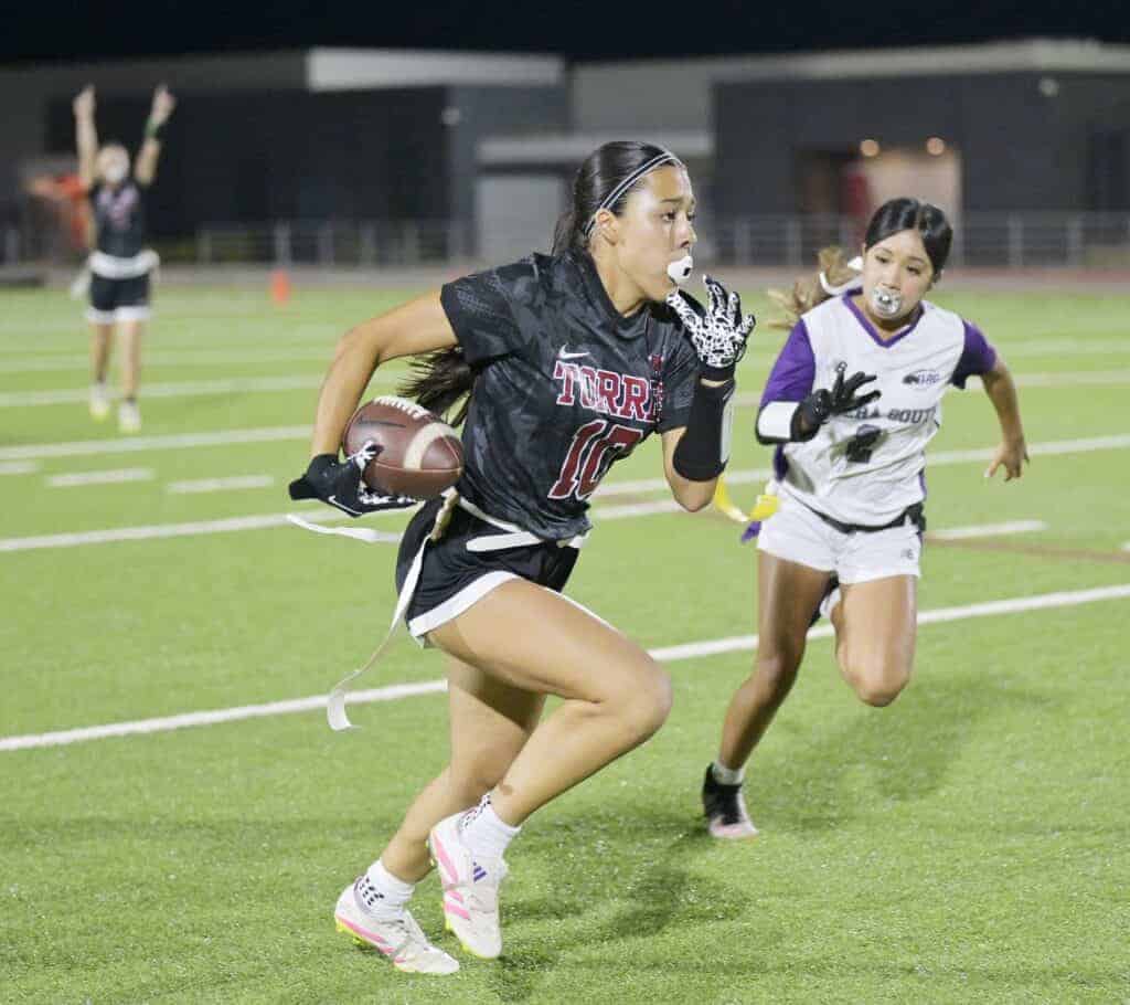 Photo - Torres’ Karina Contreras turns the corner for running room against Madera South. She scored a pair of touchdowns in the 20-0 victory.