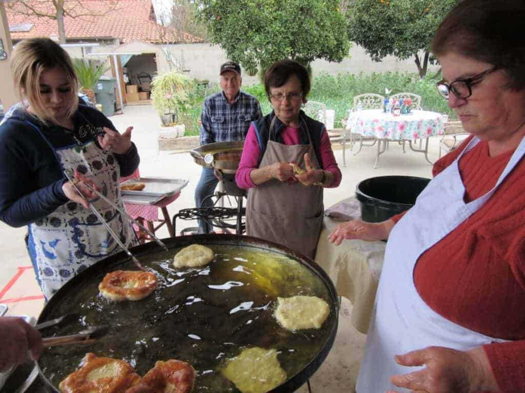 Photo - Filhoz, a Portuguese donut, cook in hot oil on Saturday. Cooks, from left, are Fatima Vieira, Joe Deniz, Sara Alvarez and Goretti Gomes. The Portuguese Fraternal Society of America, Council #108, will fund its community service projects with filhoz sales.