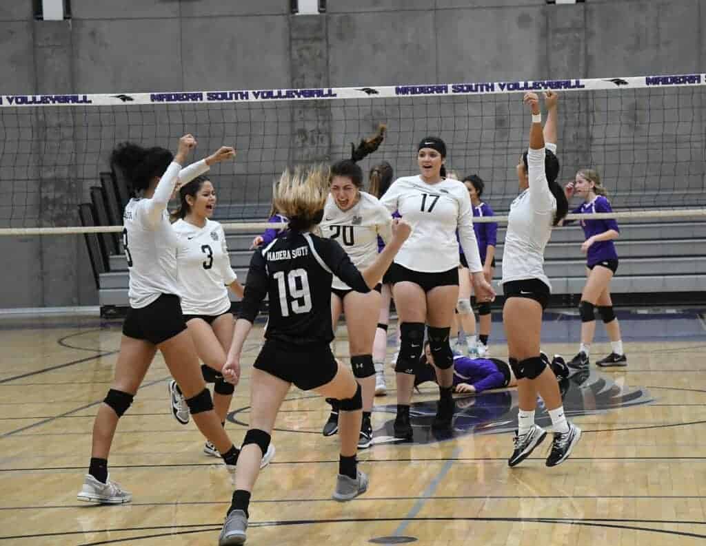 Photo - Members of the Madera South girls volleyball team celebrates winning the final point of Thursday’s CIF State NorCal quarterfinal match over Oakland Tech at Madera South.
