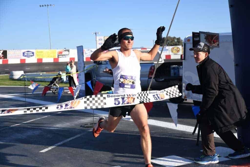 Photo - Benny Madrigal crosses the finish line at the Second Wind 5K in first place. He is the race director for the upcoming Fruit Tree 5K Run and Walk on Oct. 7.