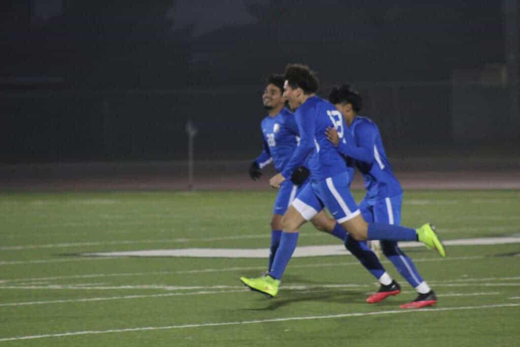 Photo - Madera;s Leonel Marquez is congratulated by Alex Segovia and Adrian Alvarado (28) after scoring the first goal in Tuesday’s 3-0 victory over Chowchilla.