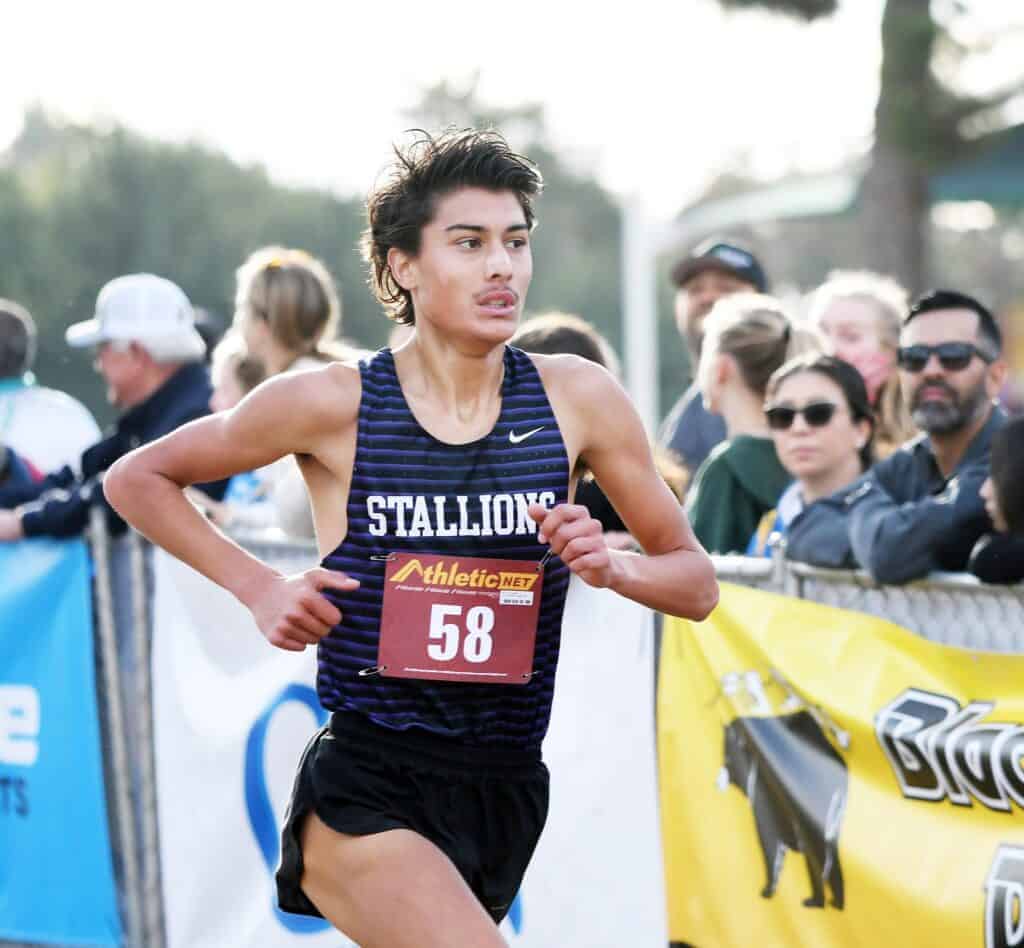 Photo - Madera South’s Dylan Devine crosses the finish line Thursday in seventh place to lead the Stallions to a second place team finish at the Central Section Championships last week. See Thursday’s Sports page for more photos from the race.