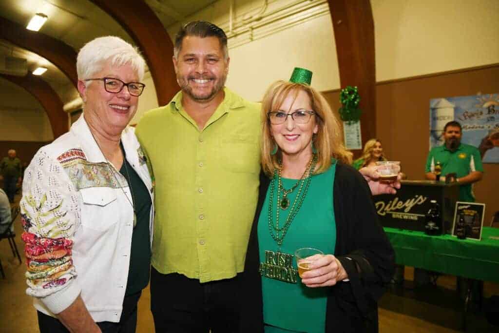 Photo - Cathi Warnock, left, visits with Daniel Riley and Cindy Vail.