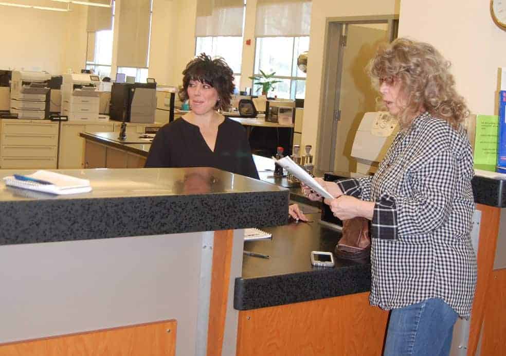 Photo - Resident Vickie Sloan, right, discusses procedures for recalling Madera Mayor Andy Medellin Friday, with elections department supervisor Stephanie Sibley at the Madera County Clerk-Recorder’s Office.
