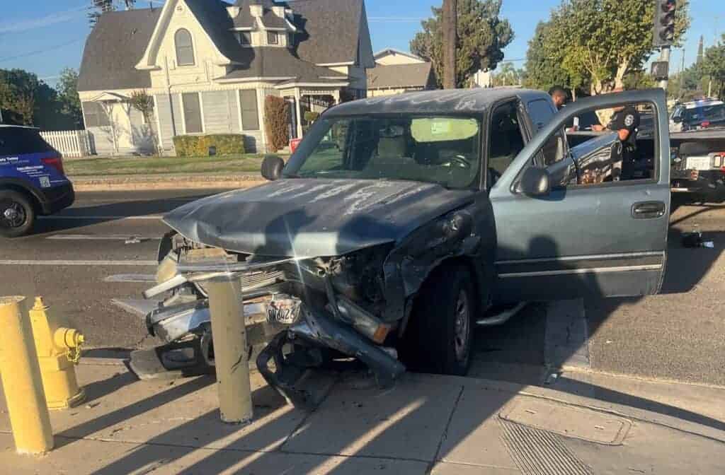 Photo - A car sits at the corner of Yosemite and Q Street after a two vehicle traffic collision. It was later determined one of the two drivers was driving under the influence of alcohol.