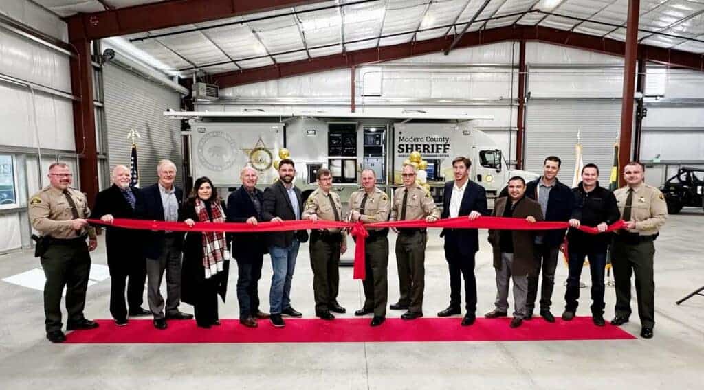 Photo - Madera County Sheriff Tyson Pogue, along with other dignitaries prepares to cut the ribbon on a new Sheriff’s Logistics Facility in Oakhurst on Tuesday.