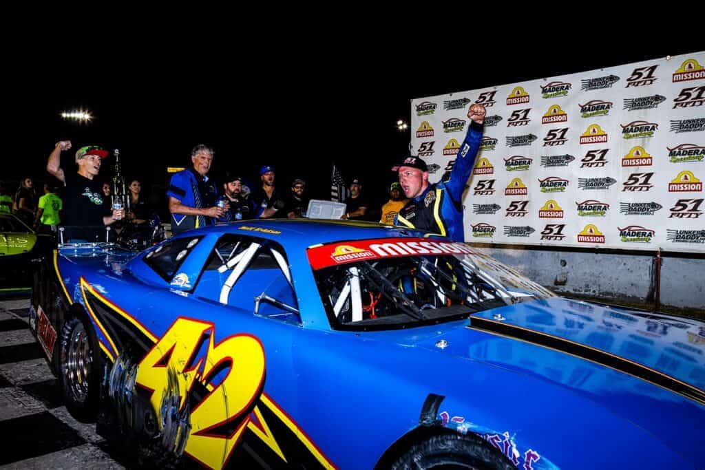 Photo - Matt Ericks celebrates his Madera Late Model victory Saturday night after a win by .053 seconds.