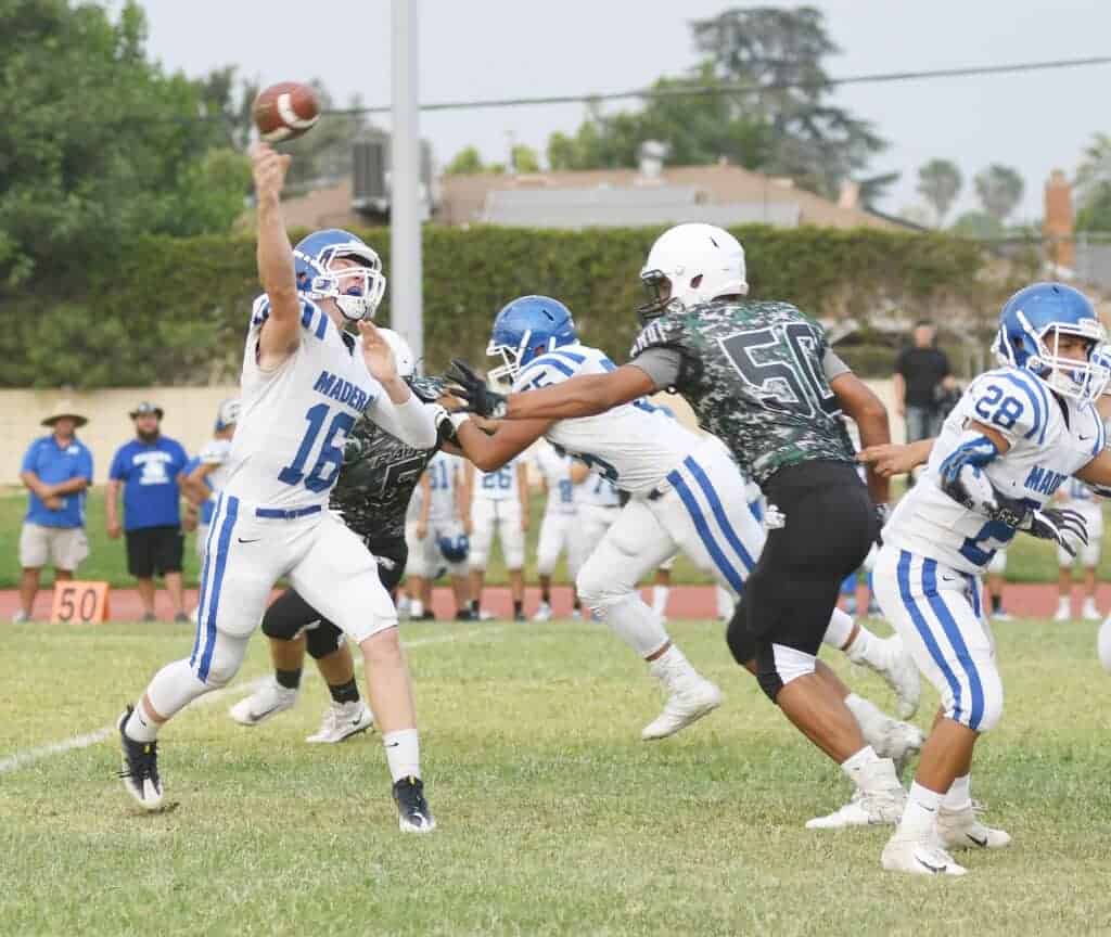 Photo - Madera quarterback Colt Nelson throws a pass during Friday’s three-way scrimmage against Hoover and Bakersfield Christian.