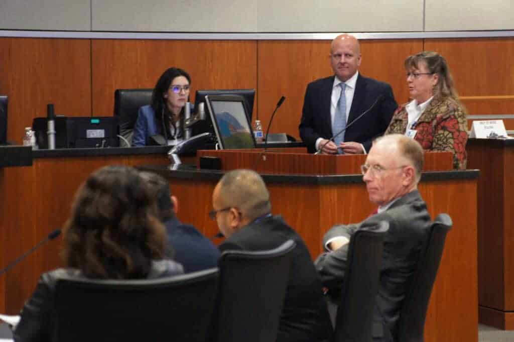 Photo - Julie Gregson, of the county’s Public Health Department, explains the benefits of an urban greening grant that will fund a walking trail with exercise stations at a new health and social services complex. Beside her stands Chief Administrative Officer Eric Fleming.
