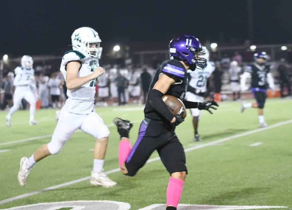 Photo - Madera South’s Justin Caballero races down the sideline for a touchdown run in Friday’s loss to Hoover.