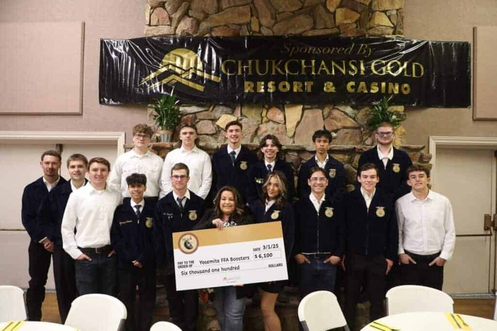 Photo - Yosemite FFA members show off the donation they received from the Picayune Rancheria to help out the auction event at their annual FFA boosters dinner.