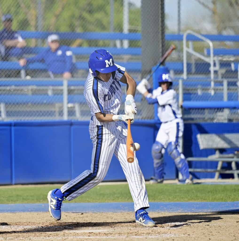 Photo - Madera’s Davion Pino swings at a pitch for a single to drive in Madera’s first run of Friday’s 3-2 loss to the Fresno Warriors. Pino was one of two Coyotes with two hits. 