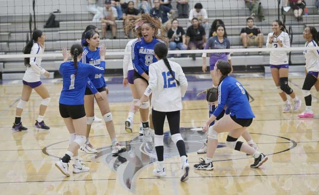 Photo - The Madera Coyotes celebrate a point during Tuesday’s three-set victory over Madera South. From left are Sky Flores (1), Belia Magana, Jania Warren (8), Evangeline Gonzalez (12) and Isabella Fessenden.