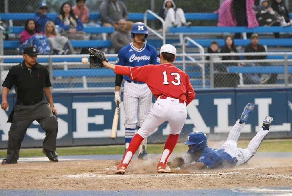 Photo - Madera’s Aaron Benividez slides in safely after scoring on a passed ball during an 11-0 victory Monday over the Chowchilla Tribe in the Fresno Easter Classic.