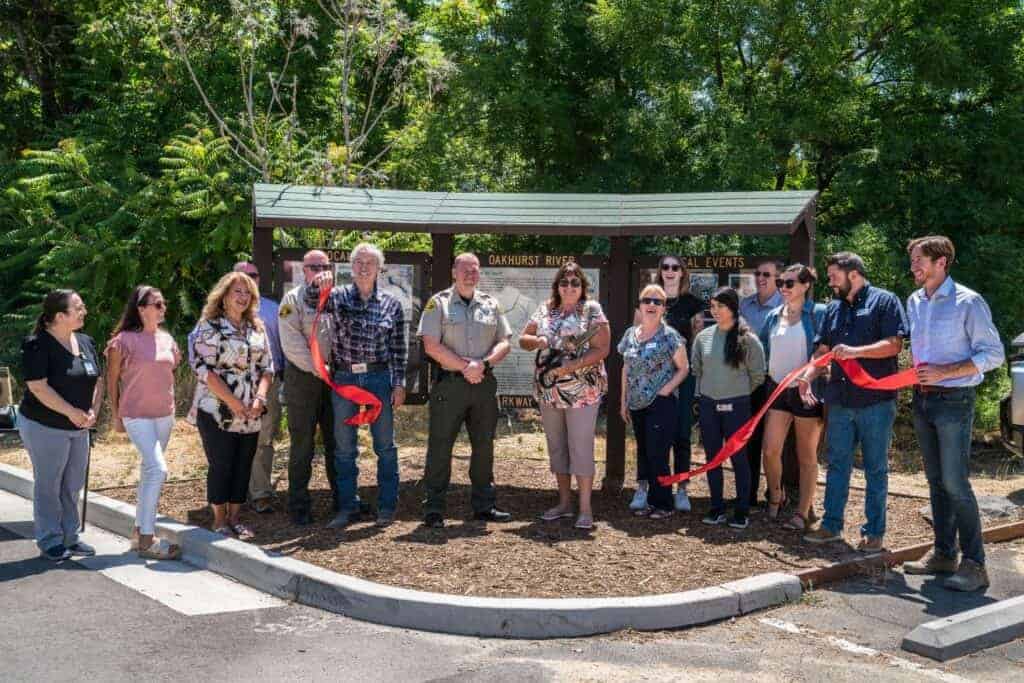 Photo - Madera County dignitaries cut the ribbon to officially open an informational kiosk and EV charging stations near the Oakhurst Library last week.