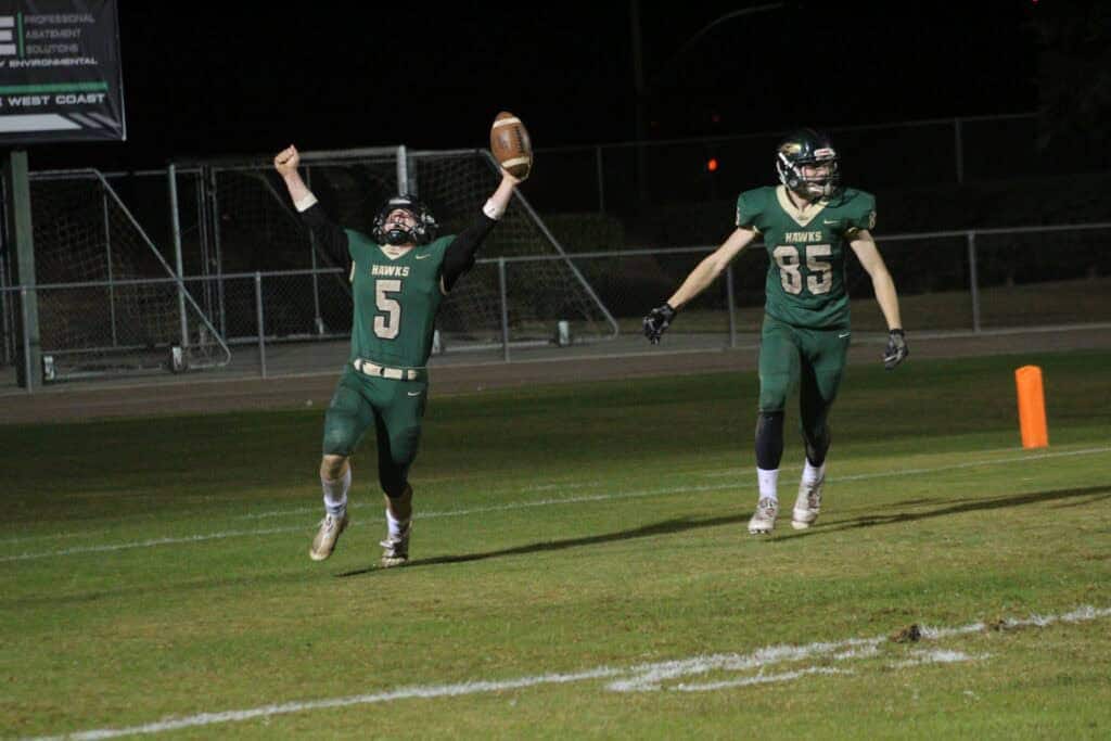 Photo - Liberty’s Brody Harlow celebrates after he scored the game-winning touchdown in Friday’s overtime victory over Chavez. Caden Moore comes in to celebrate with Harlow.