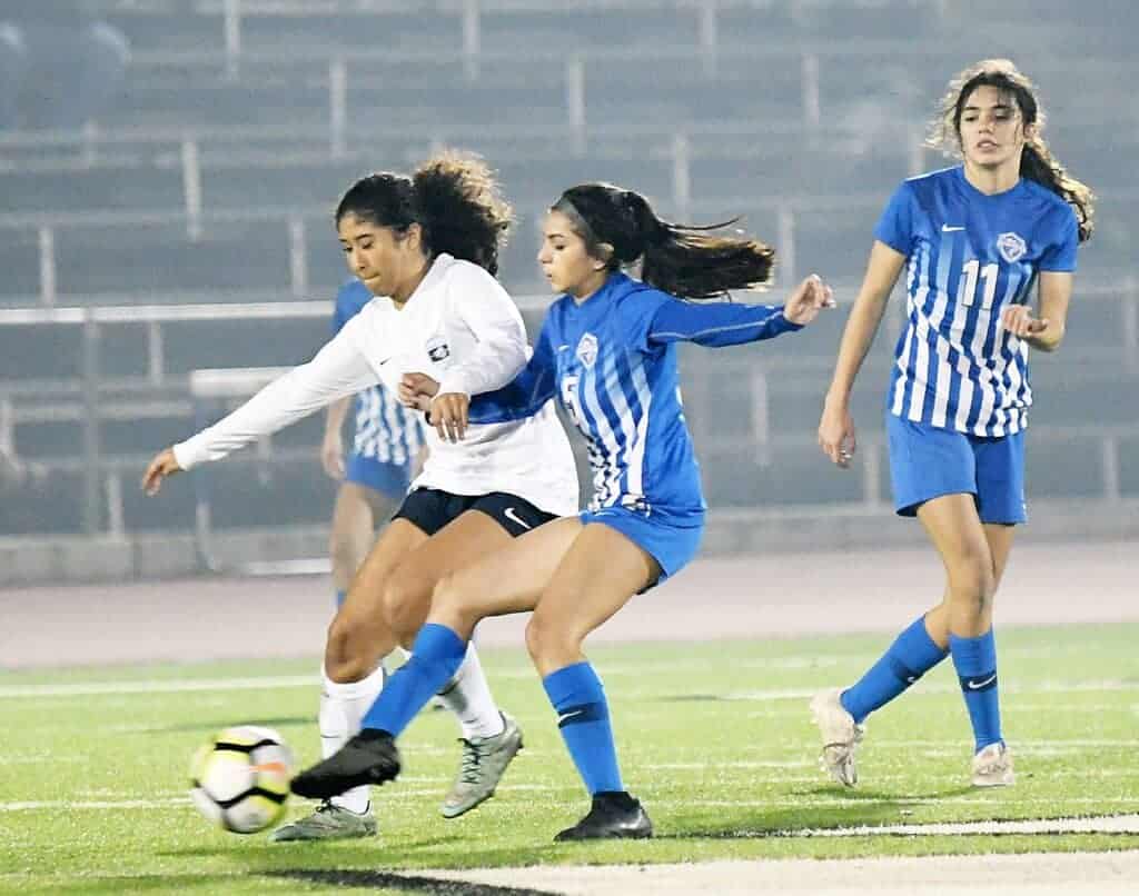 Photo - Madera’s Klarissa Ramos battles with a Bullard defender for possession during Thursday’s 2-0 loss.