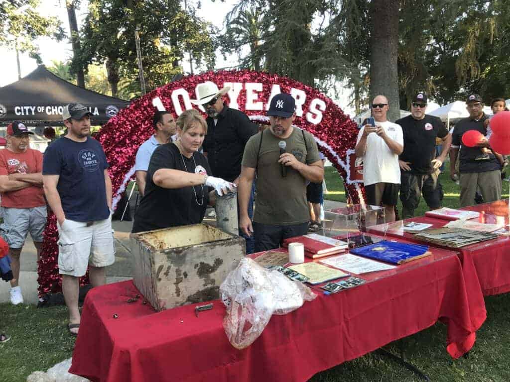 Photo - Stacy Wisener with the City of Chowchilla reveals the contents of a 25 year old time capsule during the Centennial Party in the Park at Veterans Memorial Park on Friday in celebration of Chowchilla’s 100 year anniversary.