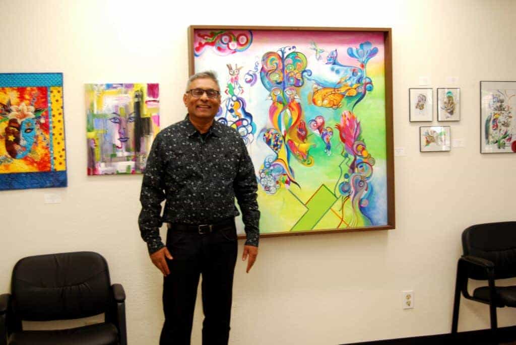 Photo - Dilesh Luhar stands in front of his artwork, Extreme Noodle Doodles.