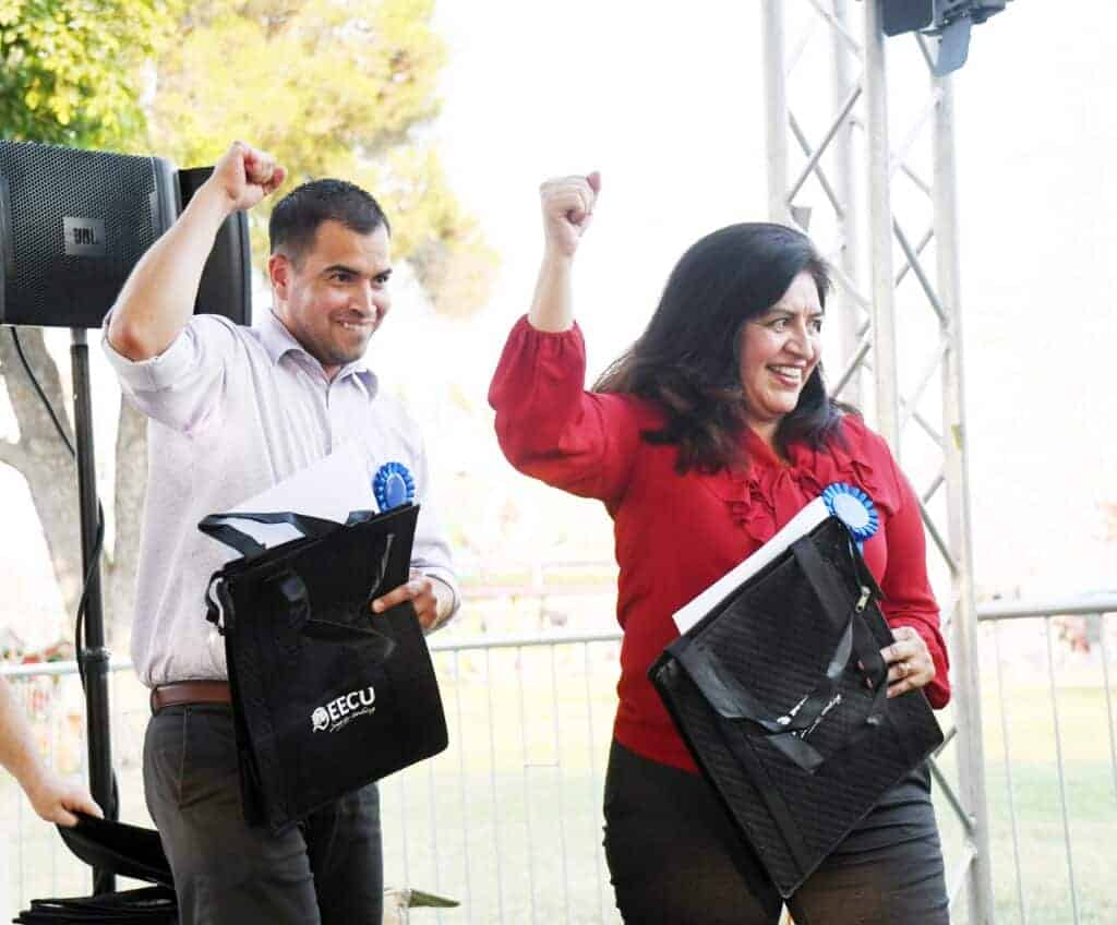 Photo - Matilda Torres High School teacher Christopher Santiago and his mother, Reina Carrera of Desmond Middle School are recognized as 2021-22 Distinguished Teachers of the Year during a ceremony at the Madera District Fair last week.
