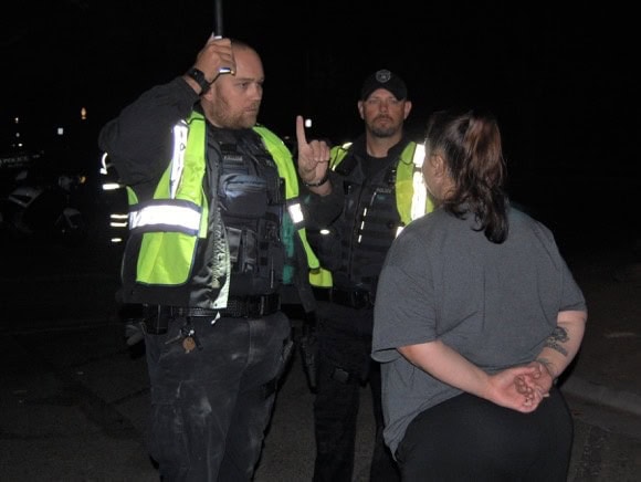 Photo - Madera police officers administer a field sobriety test to a driver suspected of being under the influence of alcohol Saturday night on Gateway Drive.