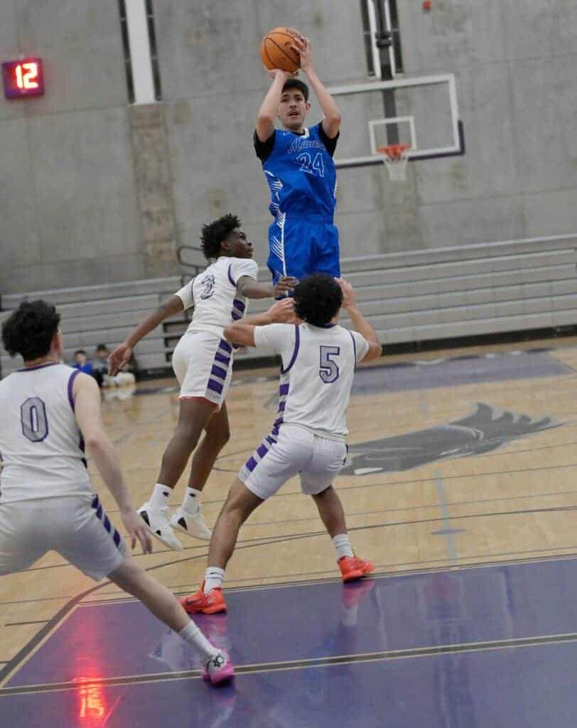 Photo - Madera’s Stevie Estrada rises over the Stallions for a jumper to score two of his team high 28 points in Wednesday’s win over Madera South. He also scored his 1,000th career point in the game, and now has 1,006.