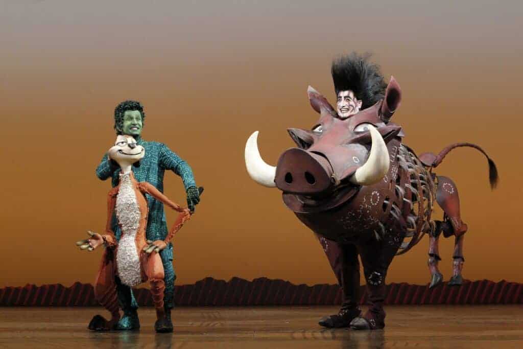 Photo - Nick Cordileone, left, and Ben Lipitz star as characters Timon and Pumba in “The Lion King.” The Broadway production of “The Lion King” begins a 12-day run, beginning tonight through Dec. 9.