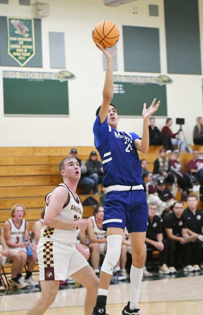 Madera High basketball player shooting during game.