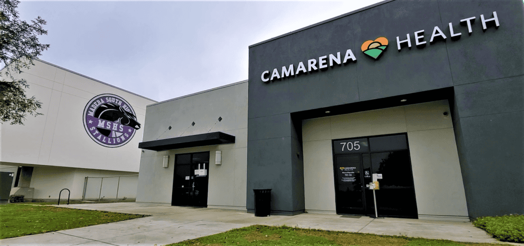 Madera Health Center building exterior with "Camarena Health" sign.