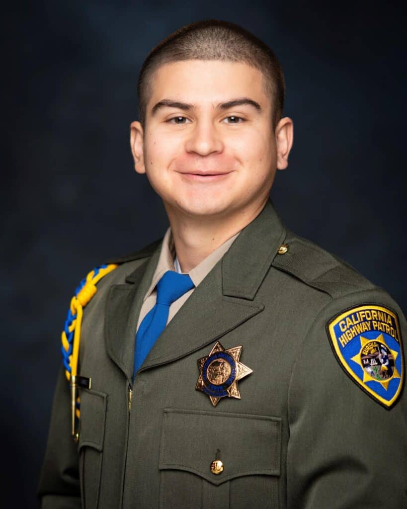 Deputy in uniform with badge and California Highway Patrol patch.