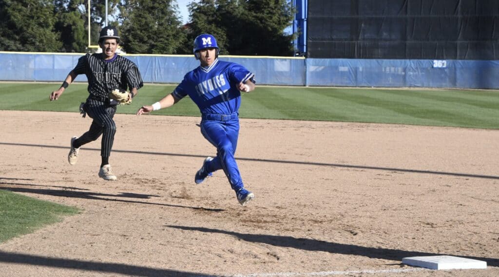 Young baseball player sprinting on the field during a game.