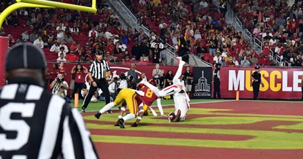 Exciting football game with players tackling on the field.