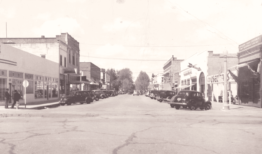 Historic Main Street in Madera with vintage cars and old storefronts.