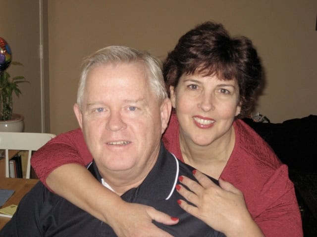 A smiling couple at a community event, showcasing local engagement and newspaper coverage.