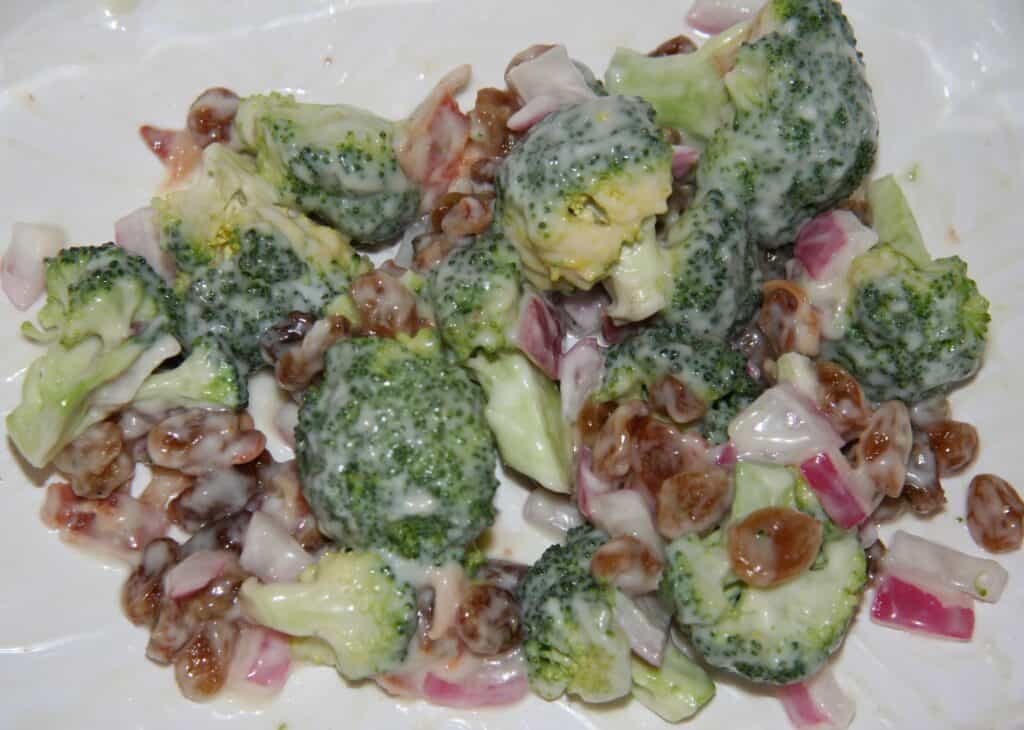 Healthy broccoli and lentil salad with red onion and dressing.