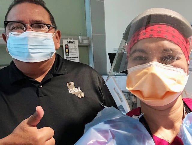 Healthcare workers wearing masks and PPE in Madera hospital.