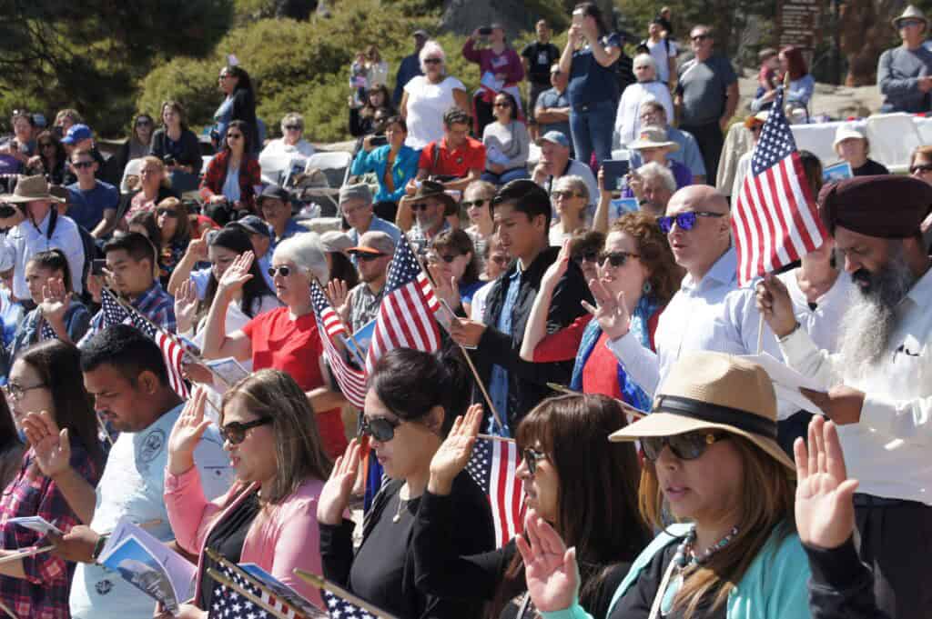 Diverse crowd celebrating Independence Day with American flags in Madera.