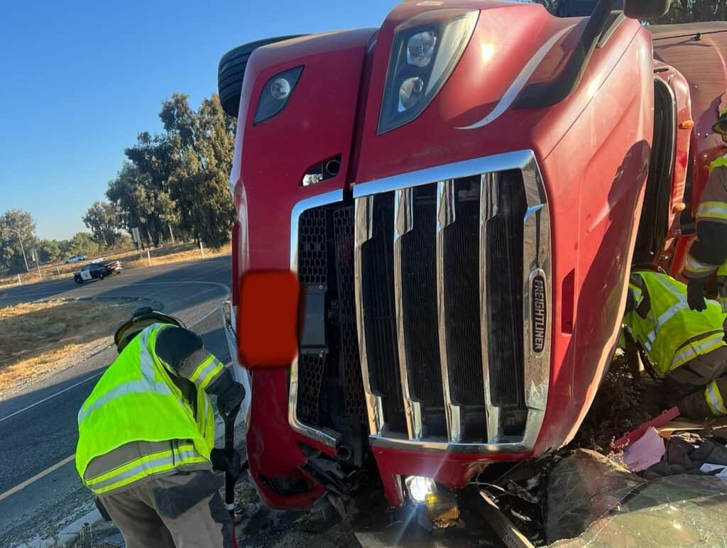 Semi-truck crash in Madera County with emergency responders assisting.