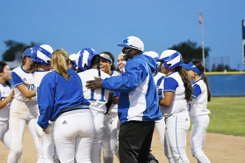 Madera Tribune softball team celebrating victory on the field.